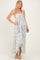 woman wearing a light blue floral maxi dress with a tie front and high-low hemline