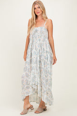 woman wearing a flowy white floral maxi dress with tie front detail and spaghetti straps