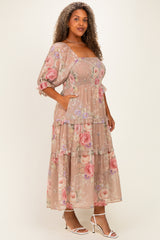 woman wearing a floral plus size maxi dress with puff sleeves and pockets, in soft pastel shades of pink and beige