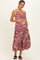 woman wearing a burgundy floral print maternity dress with a cutout detail and holding her baby bump