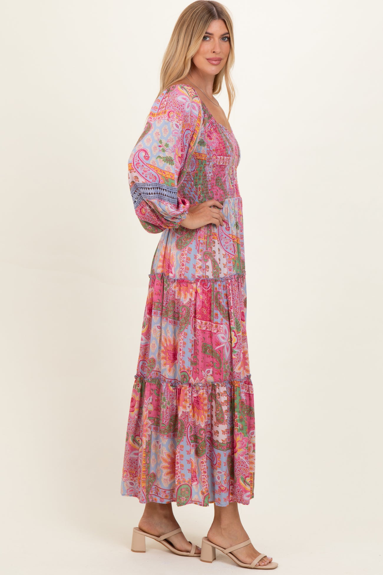 woman wearing a colorful bohemian maxi dress with puff sleeves and tiered ruffles
