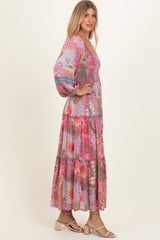 woman wearing a colorful bohemian maxi dress with puff sleeves and tiered ruffles