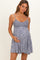 woman wearing a navy blue floral maternity dress with a fitted bodice and flared skirt, cradling her baby bump