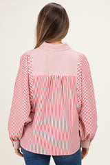 woman wearing a red and white striped maternity blouse with a relaxed fit and back pleating detail