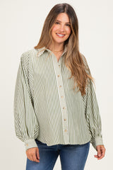 woman wearing a green and white striped maternity blouse with a button-up front and loose fit