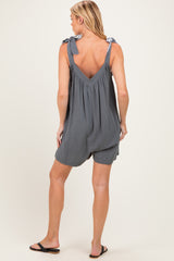 woman wearing a gray maternity romper with tie straps and a loose fit, showing her back