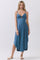 woman wearing a blue spaghetti strap midi dress with a twist front and cut-out detail