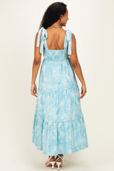 woman wearing a blue and white striped maternity maxi dress with tie shoulder straps and smocked bodice