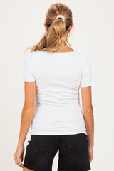 woman wearing a white short sleeve maternity top, shown from the back with a fitted style and scalloped neckline