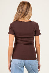 woman wearing a chocolate brown short sleeve ribbed maternity top, seen from the back