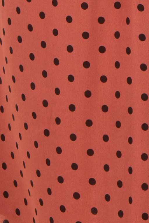 maternity wear in a rust-colored fabric with black polka dots