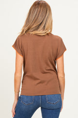 woman wearing a brown short sleeve maternity top with orange trim, showing a relaxed fit from the back