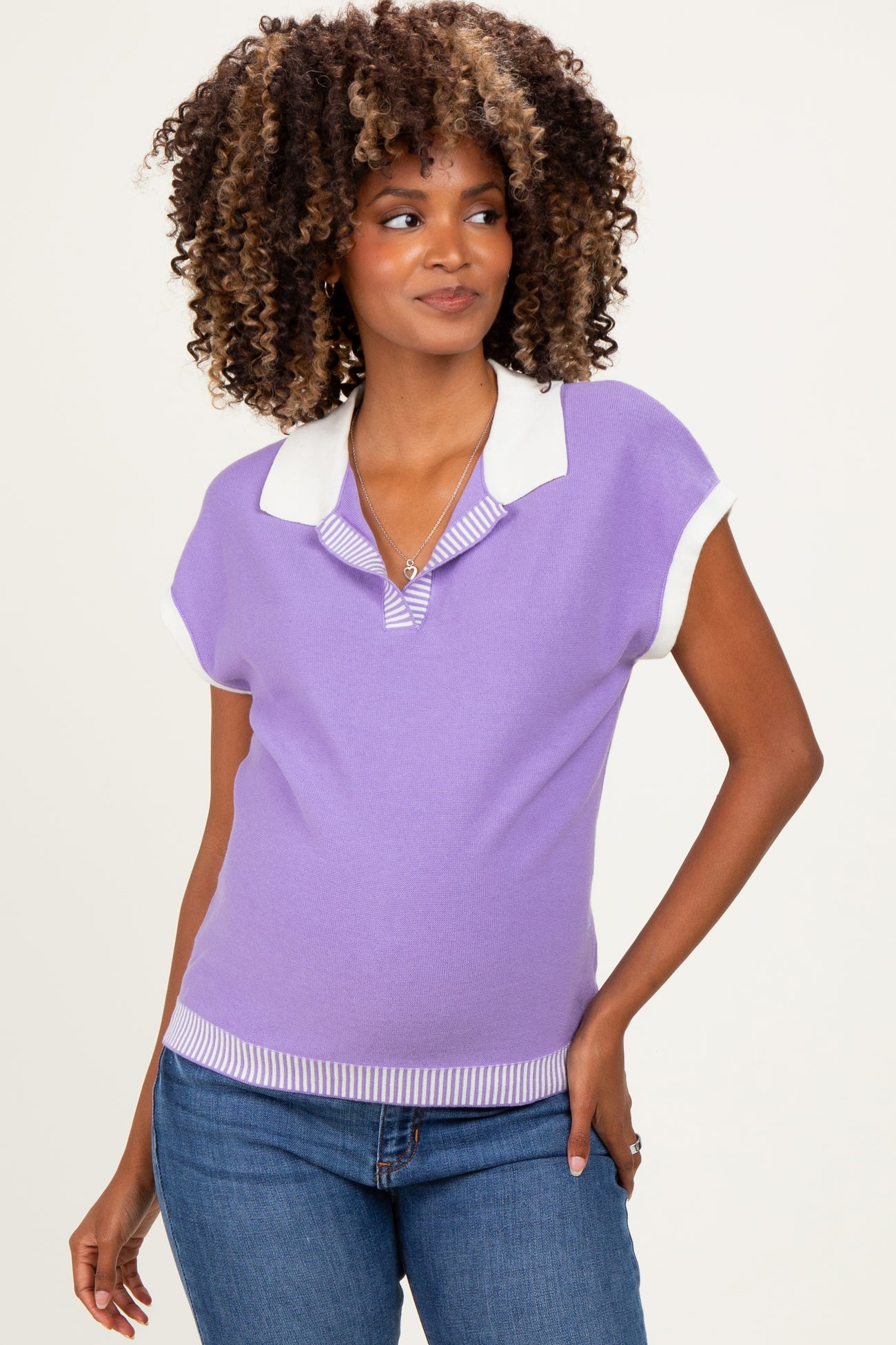 woman wearing a lavender maternity polo sweater with a white collar and short sleeves, styled with jeans