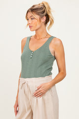woman wearing a green and white striped maternity tank top and holding her baby bump