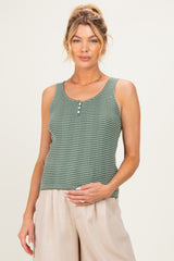 woman wearing a green checkered maternity tank top and holding her baby bump