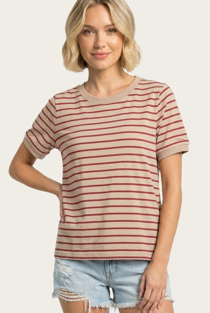 woman wearing a tan striped t-shirt with red stripes and short sleeves, paired with denim shorts