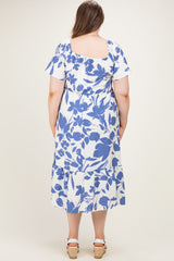 woman wearing a maternity plus floral print midi dress in blue and white with short sleeves and tiered skirt