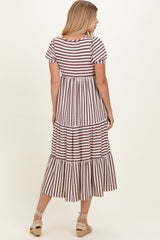woman wearing a striped tiered midi dress with short sleeves and a flowy silhouette, shown from the back