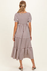 woman wearing a striped maternity maxi dress with short sleeves and tiered ruffles, showing a relaxed fit from the back