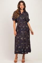 woman wearing a dark floral maternity dress with short sleeves and a fitted waist, showcasing her baby bump