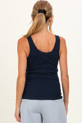 woman wearing a navy blue maternity tank top with scalloped detailing, shown from the back