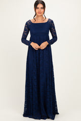 woman wearing a long sleeve navy blue lace maxi dress with a square neckline and fitted bodice