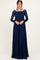 woman wearing a long sleeve navy blue lace maxi dress with a square neckline and fitted bodice