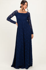 woman wearing a navy blue long sleeve lace maxi dress with a square neck and flowing skirt