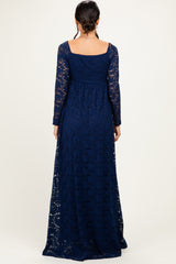 woman wearing a navy blue long sleeve lace maxi dress, showing the back view and full-length style