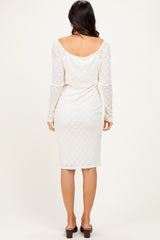 woman wearing a white lace long sleeve midi dress, showcased from the back with a fitted silhouette