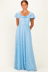 woman wearing a light blue maxi dress with ruffled sleeves and a tie-front detail