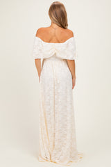 woman wearing a white off-the-shoulder maxi dress with lace detailing, shown from the back