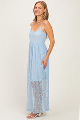 woman wearing a light blue sheer maxi dress with spaghetti straps and a flowy skirt