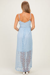 woman wearing a light blue sleeveless maxi dress with a sheer overlay and adjustable straps, back view