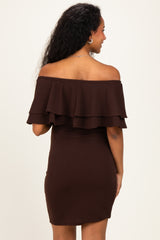 woman wearing a dark brown off-the-shoulder maternity dress with ruffle details and a fitted silhouette