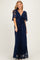 woman wearing a navy blue lace maxi dress with a tie front and short sheer sleeves