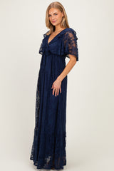 woman wearing a navy blue lace maxi dress with ruffle sleeves and a tie-front design
