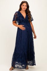 woman wearing a navy blue lace maternity maxi dress with ruffle details and a visible baby bump