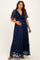 woman wearing a navy blue lace maternity maxi dress with ruffle details and a visible baby bump