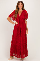 woman wearing a red lace maxi dress with flutter sleeves and a deep v-neckline