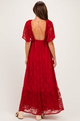 woman wearing a red lace maxi dress with short flutter sleeves and an open back detail