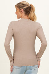 woman wearing a beige long sleeve maternity top, showing the back view with fitted ribbed details