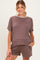 woman wearing a brown maternity short sleeve top and matching shorts with a relaxed fit