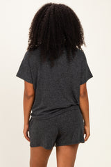 woman wearing a gray short sleeve loungewear set, showing the back view with a relaxed fit and comfortable shorts