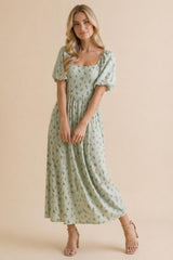 woman wearing a mint green floral midi dress with puff sleeves and a square neckline