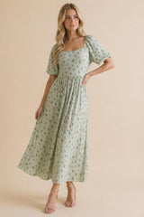 woman wearing a mint green floral maxi dress with short puff sleeves and a square neckline