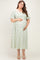 woman wearing a mint green floral maternity dress with puff sleeves and a square neckline, holding her baby bump