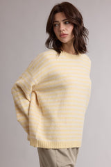 woman wearing a light yellow and white striped oversized sweater