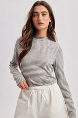 woman wearing a gray and white striped long sleeve top with a round neck and a relaxed fit