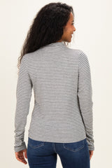 woman wearing a gray and white striped long sleeve maternity top, shown from the back, paired with blue jeans